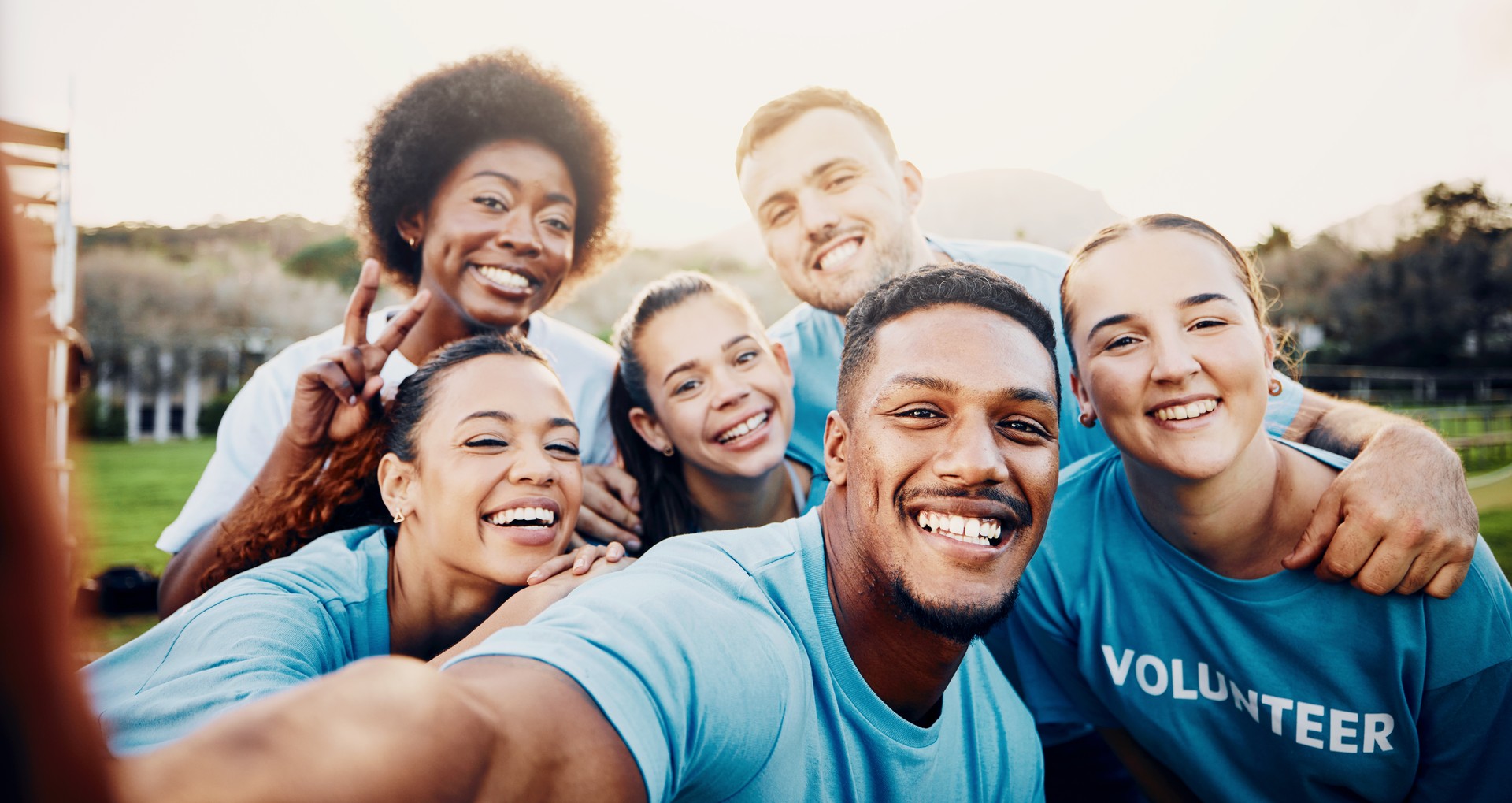 Portrait, smile and volunteer group selfie outdoors for climate change, charity cleaning and recycling. Earth day, community service and happy people laughing and taking photo with peace sign at park